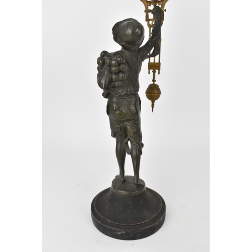 80 - A 19th century novelty mystery clock modelled as a young onion selling boy with hat, mounted on circ... 