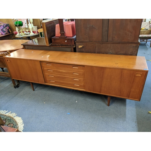 189 - A mid 20th century Clausen & Son teak sideboard having two sliding doors and four drawers, 71cm h x ... 