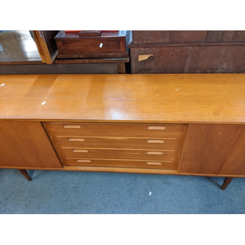 189 - A mid 20th century Clausen & Son teak sideboard having two sliding doors and four drawers, 71cm h x ... 