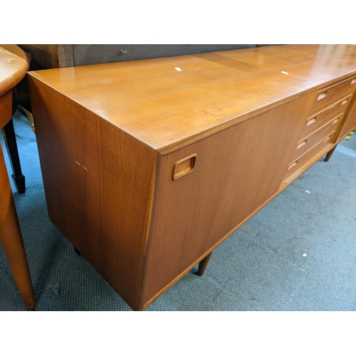 189 - A mid 20th century Clausen & Son teak sideboard having two sliding doors and four drawers, 71cm h x ... 