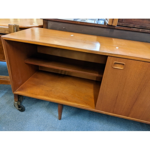 189 - A mid 20th century Clausen & Son teak sideboard having two sliding doors and four drawers, 71cm h x ... 