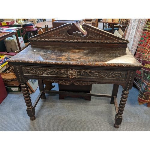 194 - A Victorian pussy oak side table having a raised back with broken swan neck pediment with inset draw... 