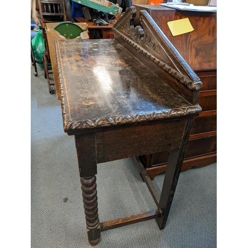 194 - A Victorian pussy oak side table having a raised back with broken swan neck pediment with inset draw... 