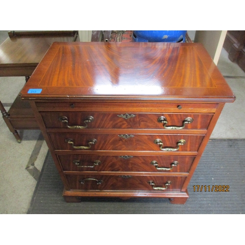 213 - A reproduction mahogany gentleman dressing chest of small proportions, four graduated drawers below ... 