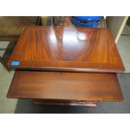 213 - A reproduction mahogany gentleman dressing chest of small proportions, four graduated drawers below ... 