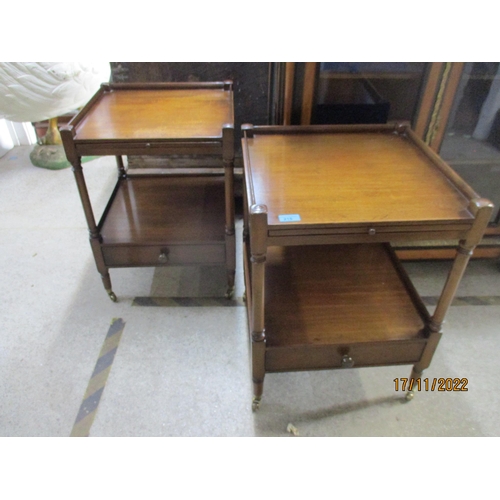 215 - A pair of reproduction mahogany bedside tables, the galleried top with brushing slide over an undert... 