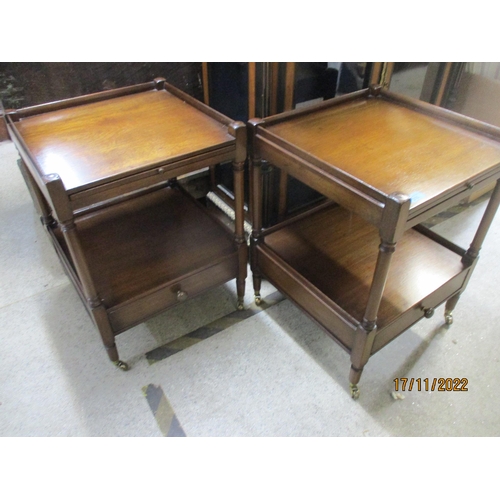 215 - A pair of reproduction mahogany bedside tables, the galleried top with brushing slide over an undert... 