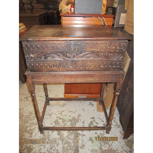 216 - A Georgian oak carved bible box with carved front having bands of S's and X's with a leaf band betwe... 