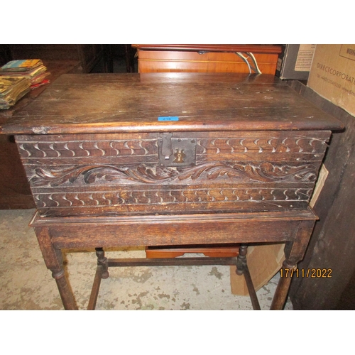 216 - A Georgian oak carved bible box with carved front having bands of S's and X's with a leaf band betwe... 