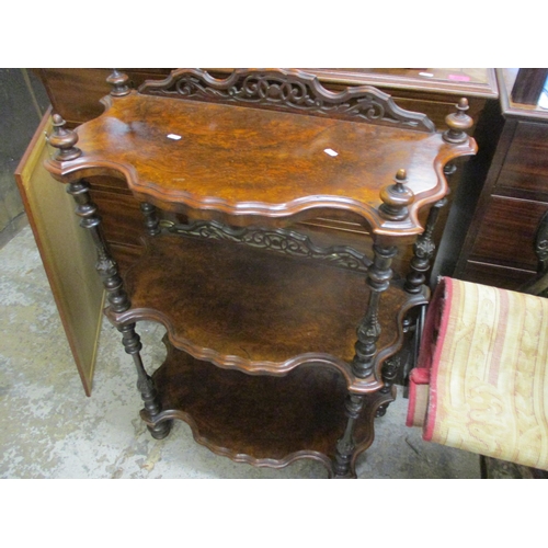 22 - A Victorian walnut three tier whatnot with turned and carved pillars Location:G