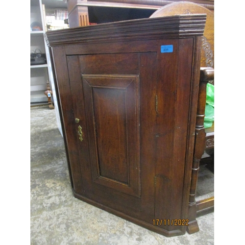 231 - A Georgian oak wall hanging corner cabinet, panelled door with brass handle and lock plate, interior... 