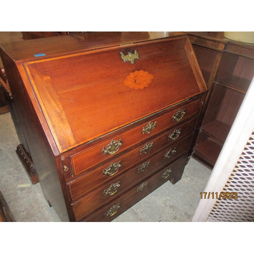 234 - A Georgian mahogany bureau with inlaid shell and stringing decoration, the fall flap revealing a fit... 