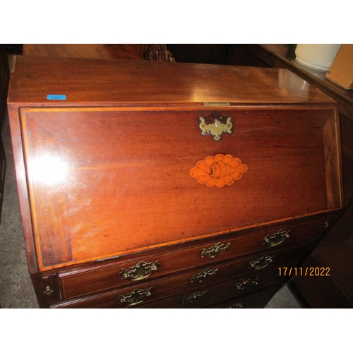 234 - A Georgian mahogany bureau with inlaid shell and stringing decoration, the fall flap revealing a fit... 