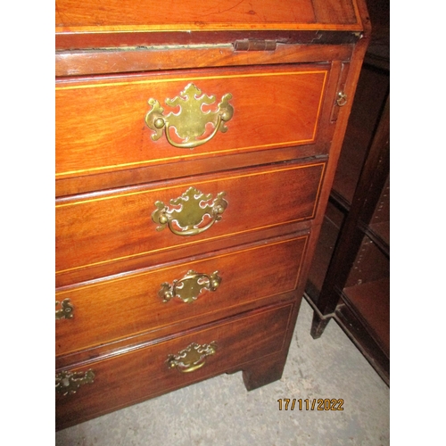 234 - A Georgian mahogany bureau with inlaid shell and stringing decoration, the fall flap revealing a fit... 