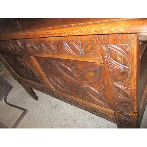 239 - An 18th century oak coffer with carved panelled front, panelled sides and back, on stile feet 76cm x... 