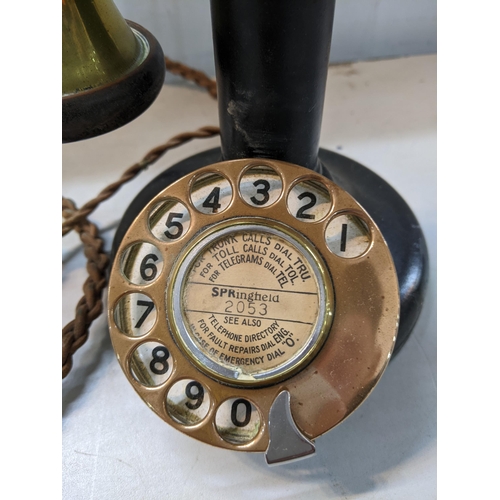 24 - A black painted and brass candlestick telephone Location: 10.1