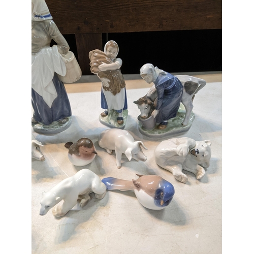 48 - Royal Copenhagen porcelain models and figures to include a woman feeding a cow, a girl, a woman with... 