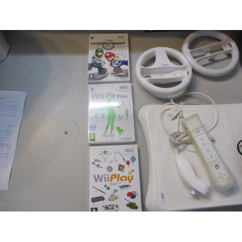 65 - A Nintendo Wii, together with a balance board, games and accessories Location:LWB/FSL