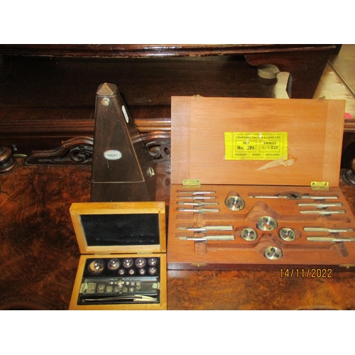 70 - A lot to include a Paquet wooden cased metronome, a set of German chemist scale weights, boxed, and ... 