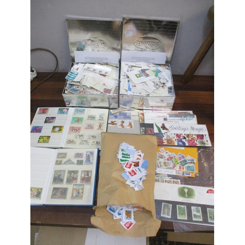 81 - A quantity of stamps to include two tins of mainly Belgium loose stamps, two albums of Magyar and Ea... 