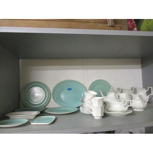 83 - A group of Poole pottery two-tone plates and meat platters, and a Johnson Bros part dinner service L... 