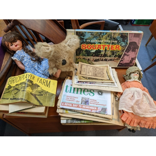 178 - A mixed lot to include dolls, Koala bear doll, commemorative newspapers and boxed games to include T... 