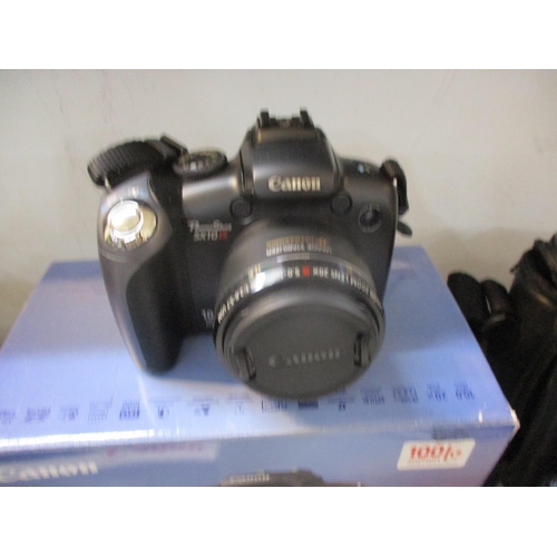 188 - A mixed lot of cameras and a portable radio to include a Canon Powershot SX10is 10.0mpx, a Canon Sur... 