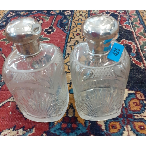 425 - A pair of glass dressing table bottles with white metal lids Location: A3B