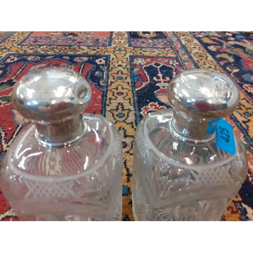 425 - A pair of glass dressing table bottles with white metal lids Location: A3B