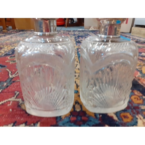 425 - A pair of glass dressing table bottles with white metal lids Location: A3B