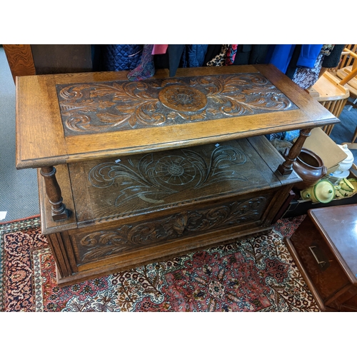 10 - An early 20th century oak carved monk's bench having a hinged seat with storage 96cm h x 106cm w Loc... 