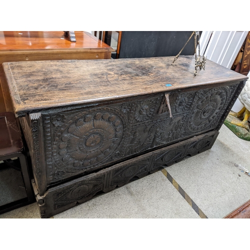 447 - An 18th century Continental, possibly Dutch, oak coffer having a carved front decorated with figures... 