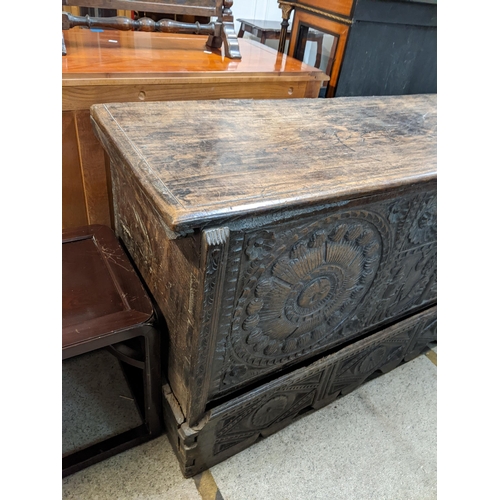 447 - An 18th century Continental, possibly Dutch, oak coffer having a carved front decorated with figures... 