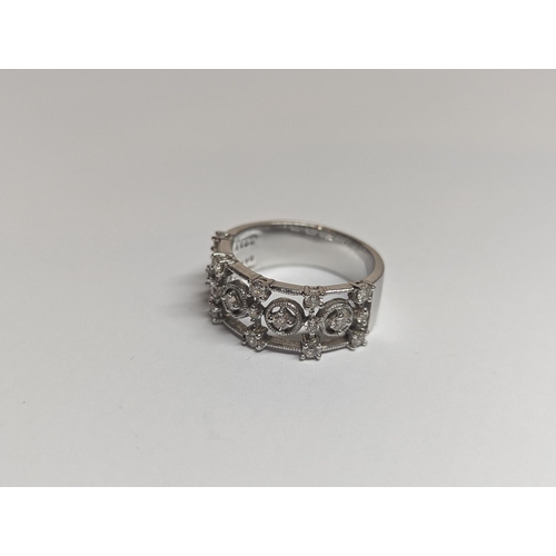 182 - A designer 18ct white gold ring inset with 19 diamonds in a pierced setting 6.4g, along with an unre... 