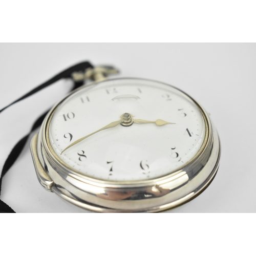 106 - A George III silver pair cased pocket watch having a white enamel dial, silvered hands and Arabic nu... 