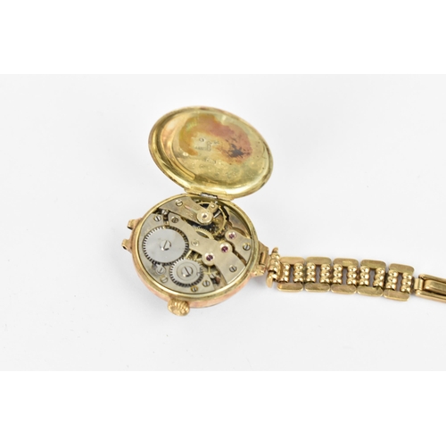 21 - An early 20th century ladies 9ct gold cased manual wind wristwatch having a white enamel dial with A... 