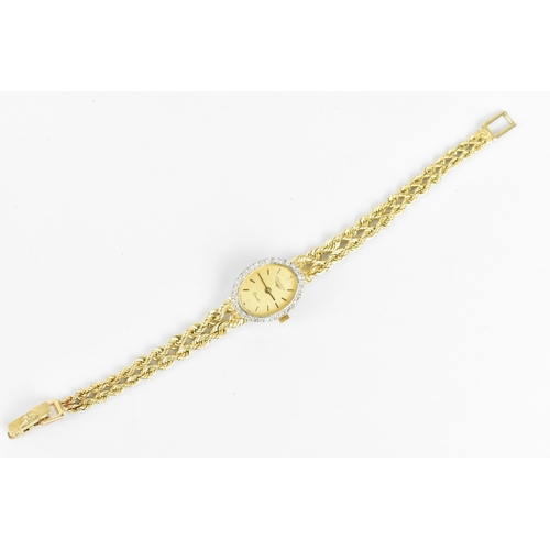 30 - A Longines quartz, ladies 14ct gold wristwatch having a diamond bezel, gilt dial with baton markers,... 