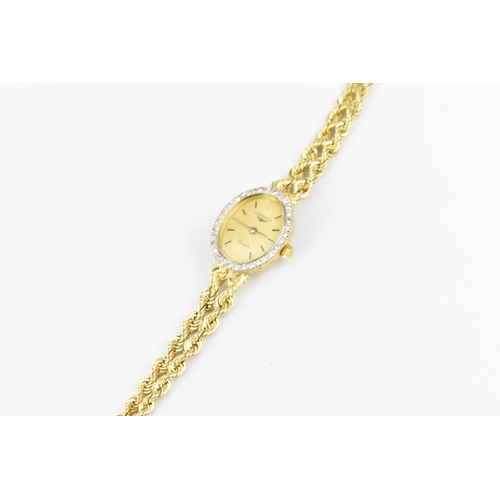 30 - A Longines quartz, ladies 14ct gold wristwatch having a diamond bezel, gilt dial with baton markers,... 