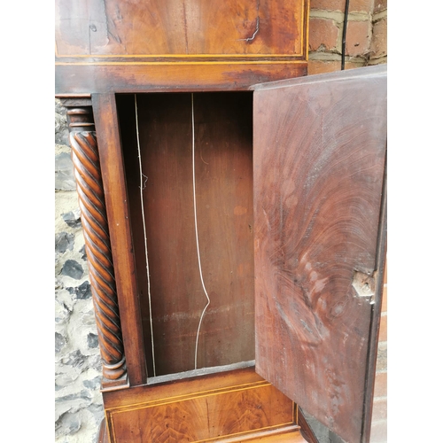 38 - A George III mahogany longcase clock having an arched top with turned finials, twin columns flanking... 