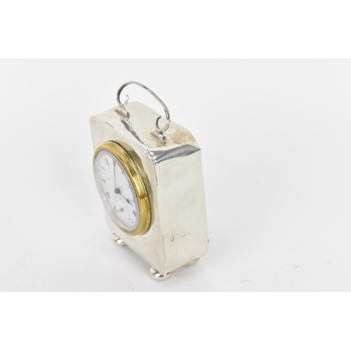 40 - An early 20th century miniature silver cased carriage clock, the case having scroll handle with turn... 