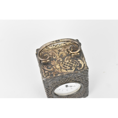 55 - An early 20th century silver cased carriage clock, the embossed case decorated with C scrolls and st... 