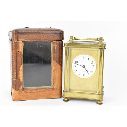 60 - An early 20th century brass cased carriage clock in a fitted travel case having a white enamel dial ... 