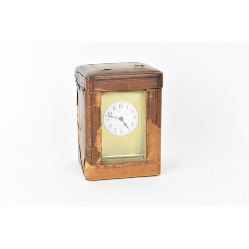 60 - An early 20th century brass cased carriage clock in a fitted travel case having a white enamel dial ... 