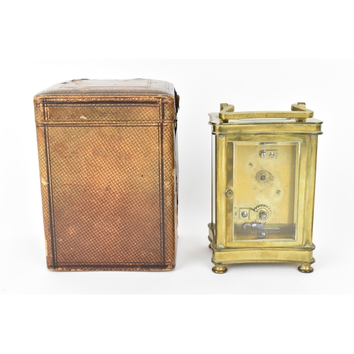 60 - An early 20th century brass cased carriage clock in a fitted travel case having a white enamel dial ... 