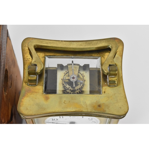 60 - An early 20th century brass cased carriage clock in a fitted travel case having a white enamel dial ... 