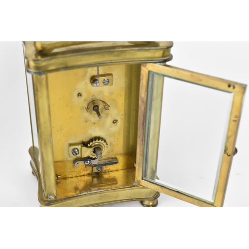 60 - An early 20th century brass cased carriage clock in a fitted travel case having a white enamel dial ... 