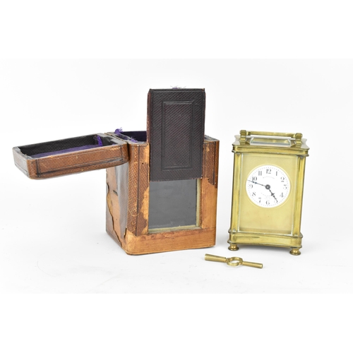 60 - An early 20th century brass cased carriage clock in a fitted travel case having a white enamel dial ... 