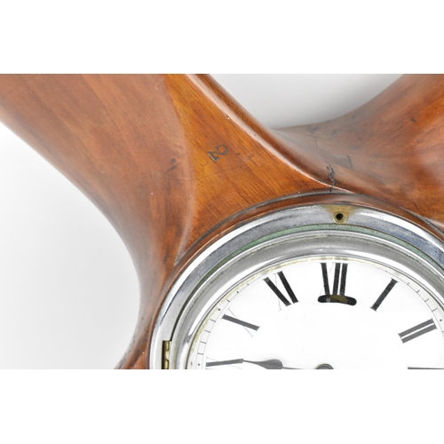 85 - An early 20th century clock set in a propeller hub, the 6.5 inch dial having Roman numerals with a c... 