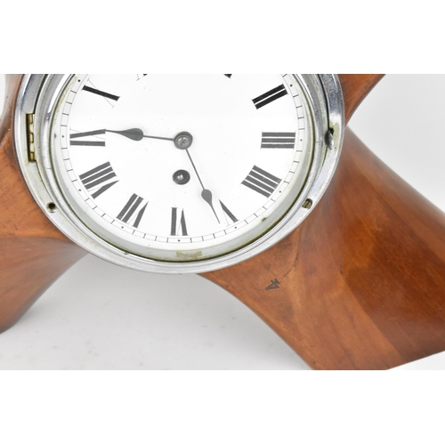 85 - An early 20th century clock set in a propeller hub, the 6.5 inch dial having Roman numerals with a c... 