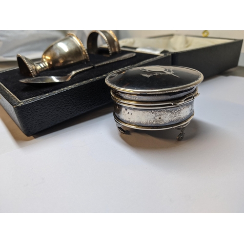 25 - A late 20th century silver three piece Christening set comprising an egg cup, a napkin ring and a sp... 